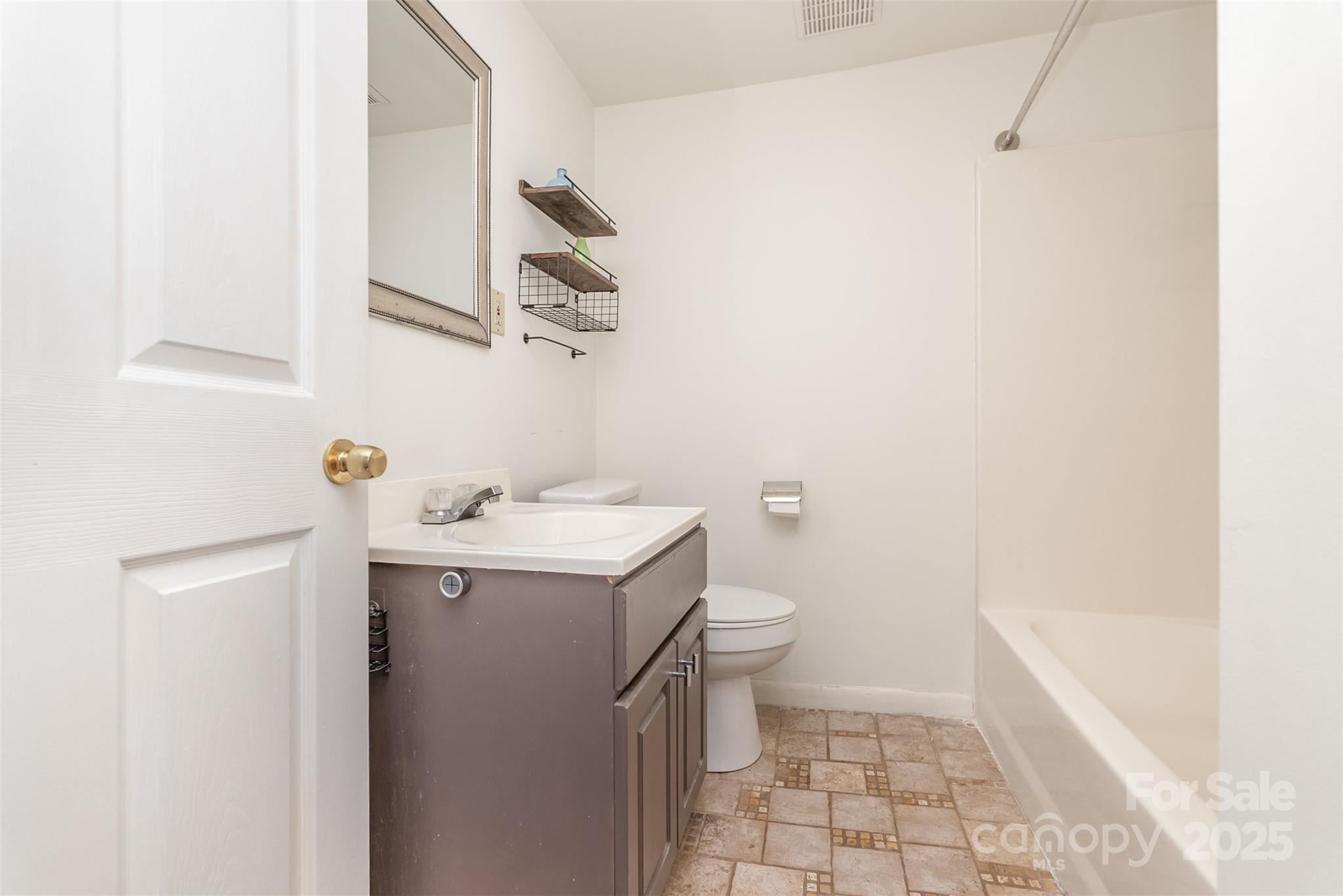 243 Boys Camp Road Black Mountain, NC 28711 - Photo 18 of 21 a bathroom with a sink a toilet and shower