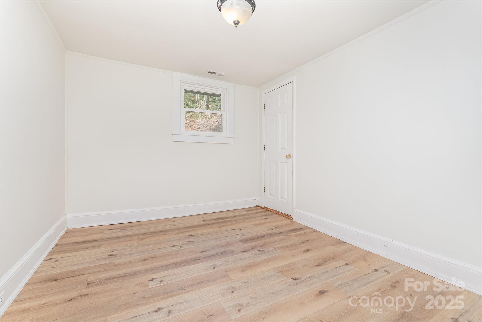 243 Boys Camp Road Black Mountain, NC 28711 - Photo 19 of 21 a view of an empty room with wooden floor