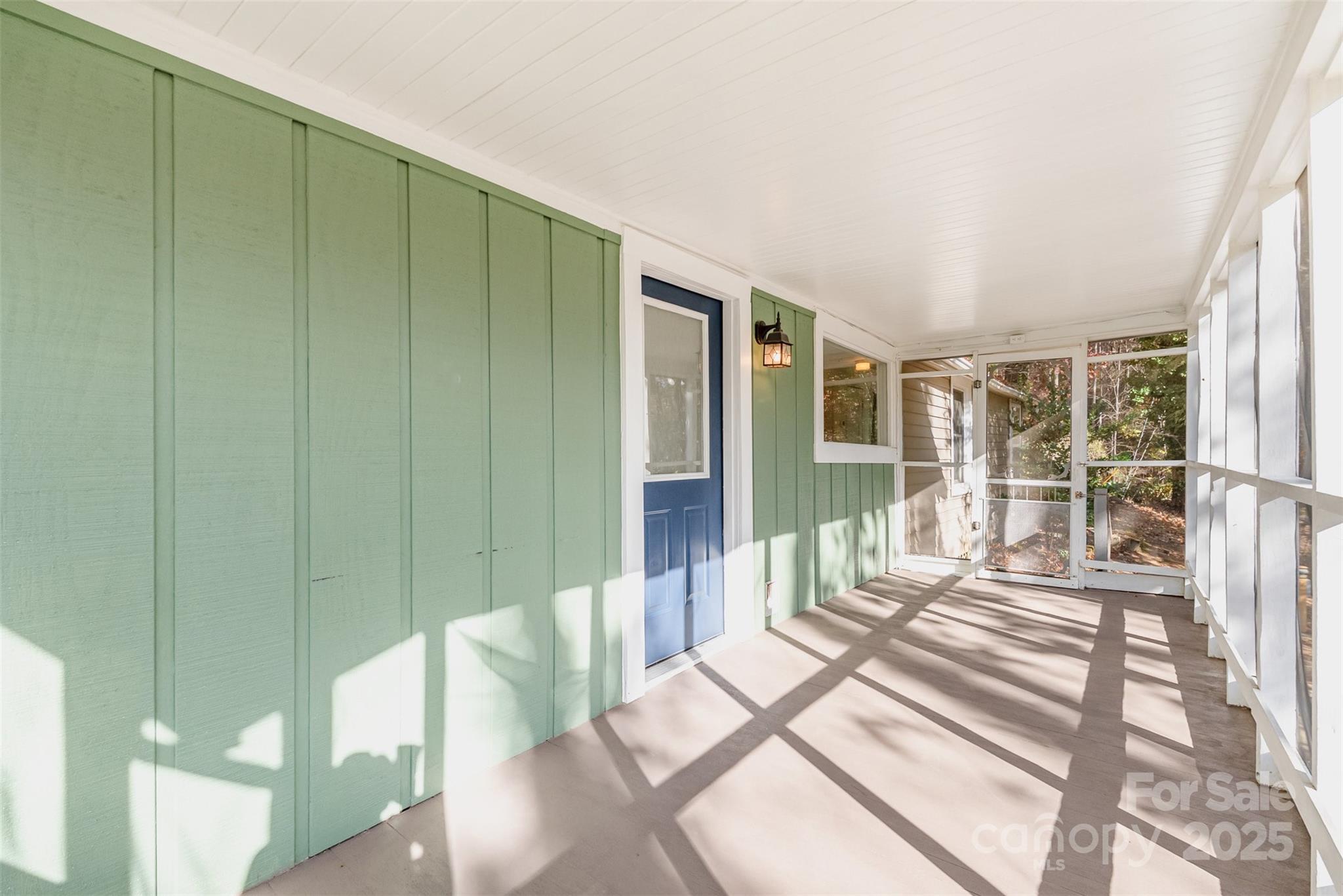 243 Boys Camp Road Black Mountain, NC 28711 - Photo 5 of 21 a view of a bedroom with wooden floor and windows