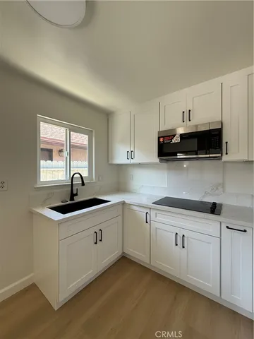 a kitchen with stainless steel appliances granite countertop a sink stove and cabinets