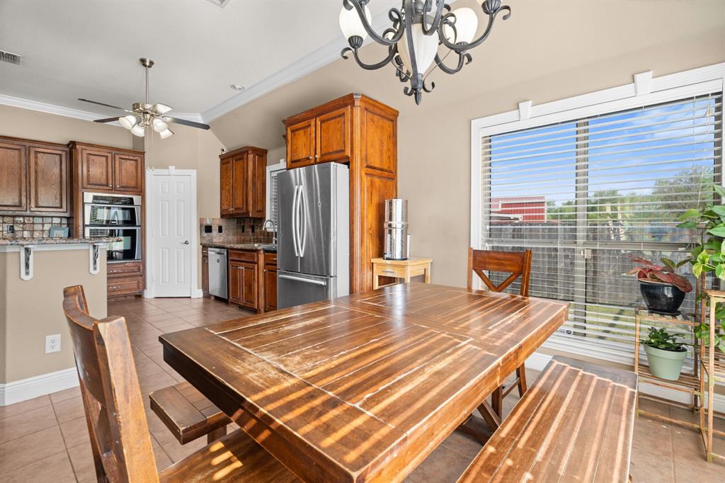 112 Waterfall Court Azle, TX 76020 - Photo 14 of 40 a dining room with wooden floor and stainless steel appliances