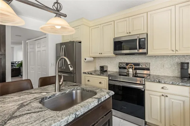 a kitchen with a sink cabinets and a window
