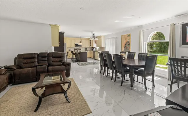 a living room with furniture a window and a flat screen tv