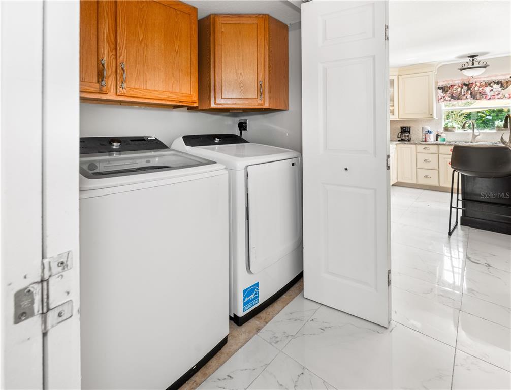 51 Uhl Path Palm Coast, FL 32164 - Photo 26 of 68 a utility room with cabinets washer and dryer