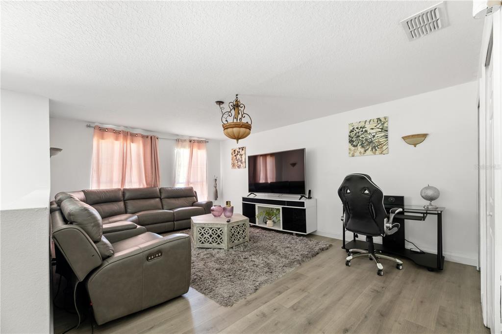 51 Uhl Path Palm Coast, FL 32164 - Photo 29 of 68 a living room with furniture a window and a flat screen tv