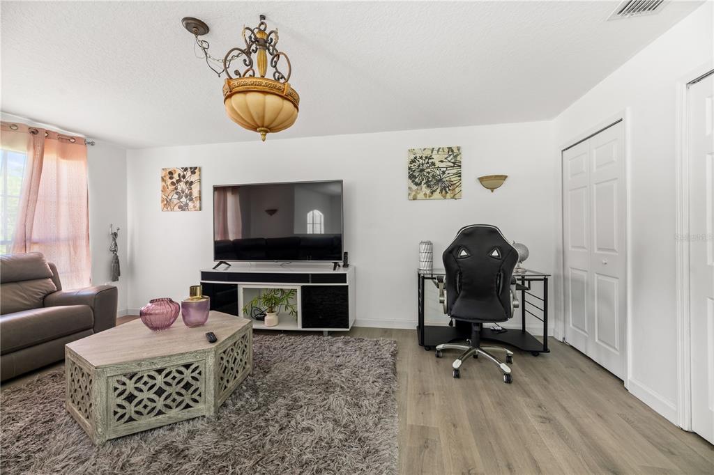 51 Uhl Path Palm Coast, FL 32164 - Photo 30 of 68 a living room with furniture a rug and a flat screen tv