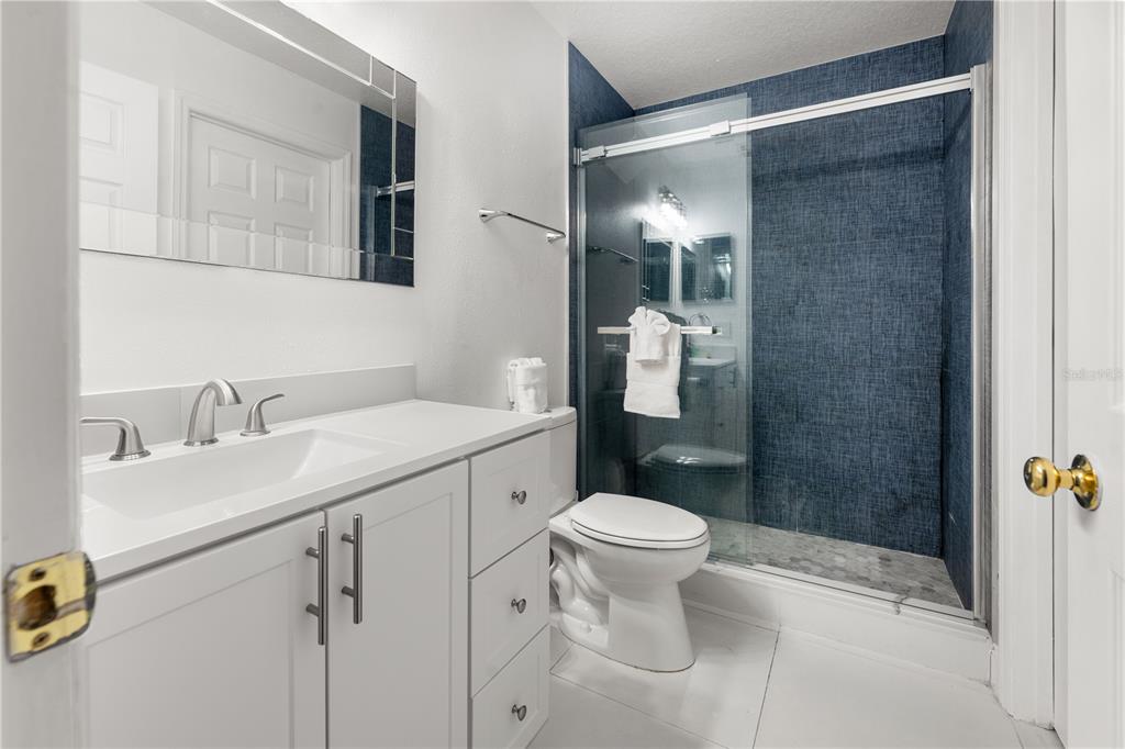 51 Uhl Path Palm Coast, FL 32164 - Photo 32 of 68 a bathroom with a sink toilet a mirror and shower
