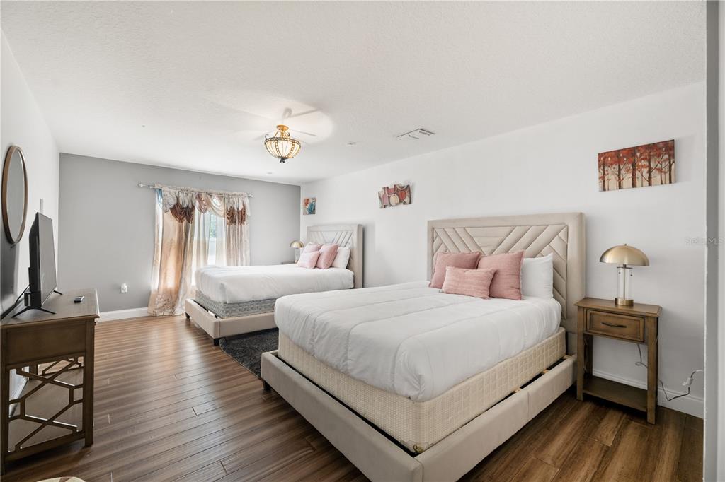 51 Uhl Path Palm Coast, FL 32164 - Photo 41 of 68 a bedroom with two beds and a chandelier