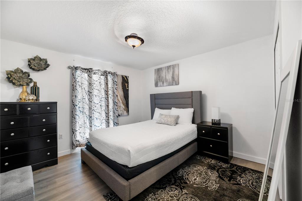 51 Uhl Path Palm Coast, FL 32164 - Photo 43 of 68 a bedroom with a bed and a dresser