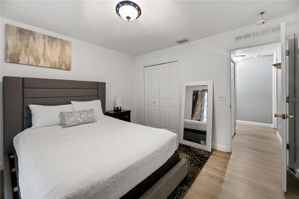 51 Uhl Path Palm Coast, FL 32164 - Photo 44 of 68 a bedroom with a bed and a chandelier