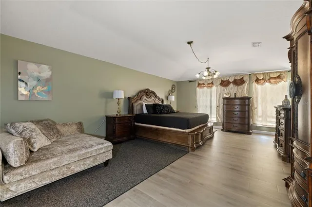 an aerial view of a house with a yard basket ball court and a patio