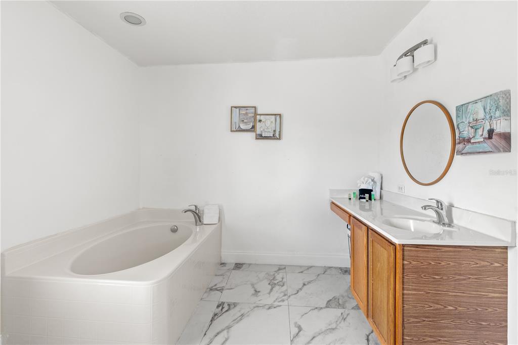 51 Uhl Path Palm Coast, FL 32164 - Photo 50 of 68 a bathroom with a sink and a mirror