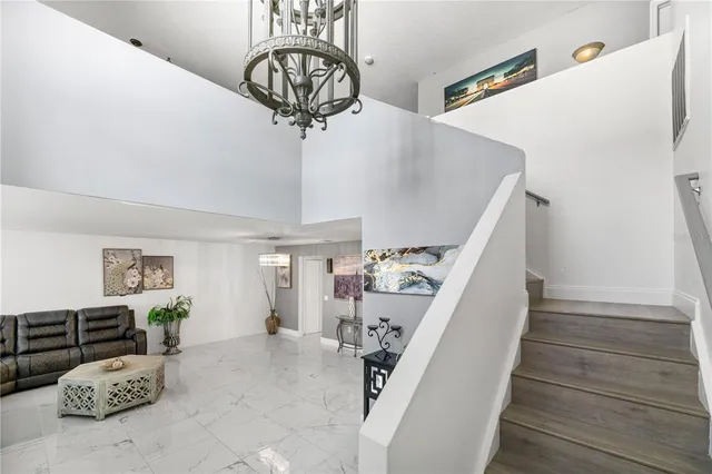a living room with furniture a flat screen tv and a window