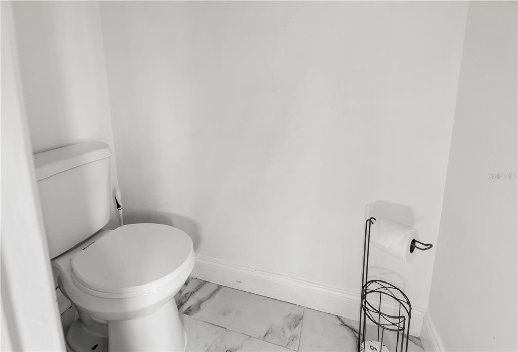51 Uhl Path Palm Coast, FL 32164 - Photo 54 of 68 a white toilet sitting next to a shower
