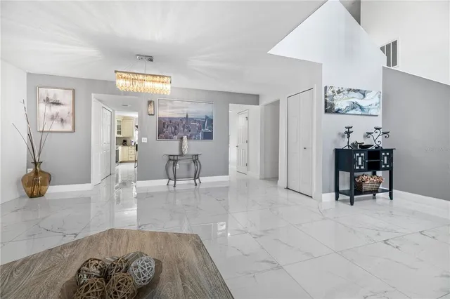 a living room with furniture and a chandelier