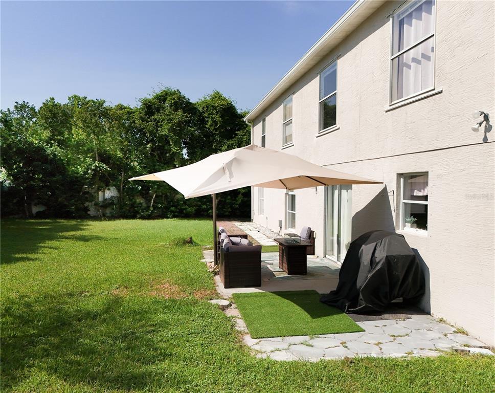 51 Uhl Path Palm Coast, FL 32164 - Photo 61 of 68 a view of a white house with a big yard and potted plants