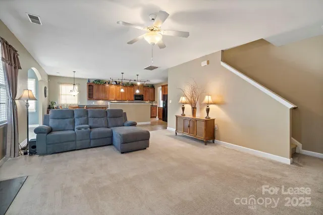 a living room with furniture and a chandelier