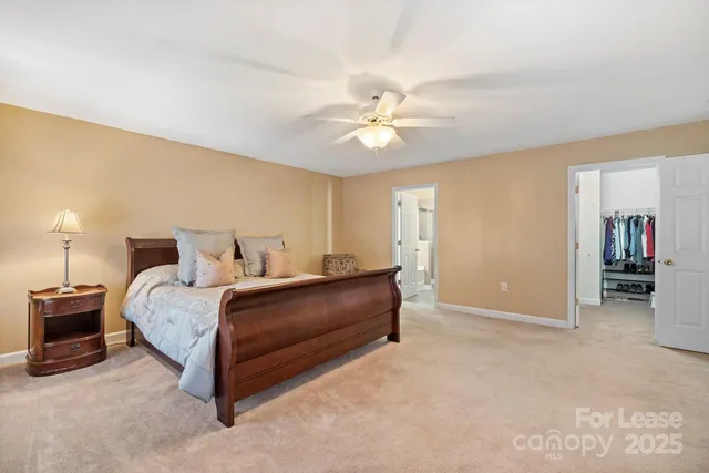 a spacious bedroom with a bed and a chandelier