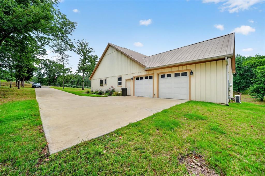 5230 Esquire Estates Road Mabank, TX 75156 - Photo 31 of 39 Cream-colored vertical siding with a metal roof