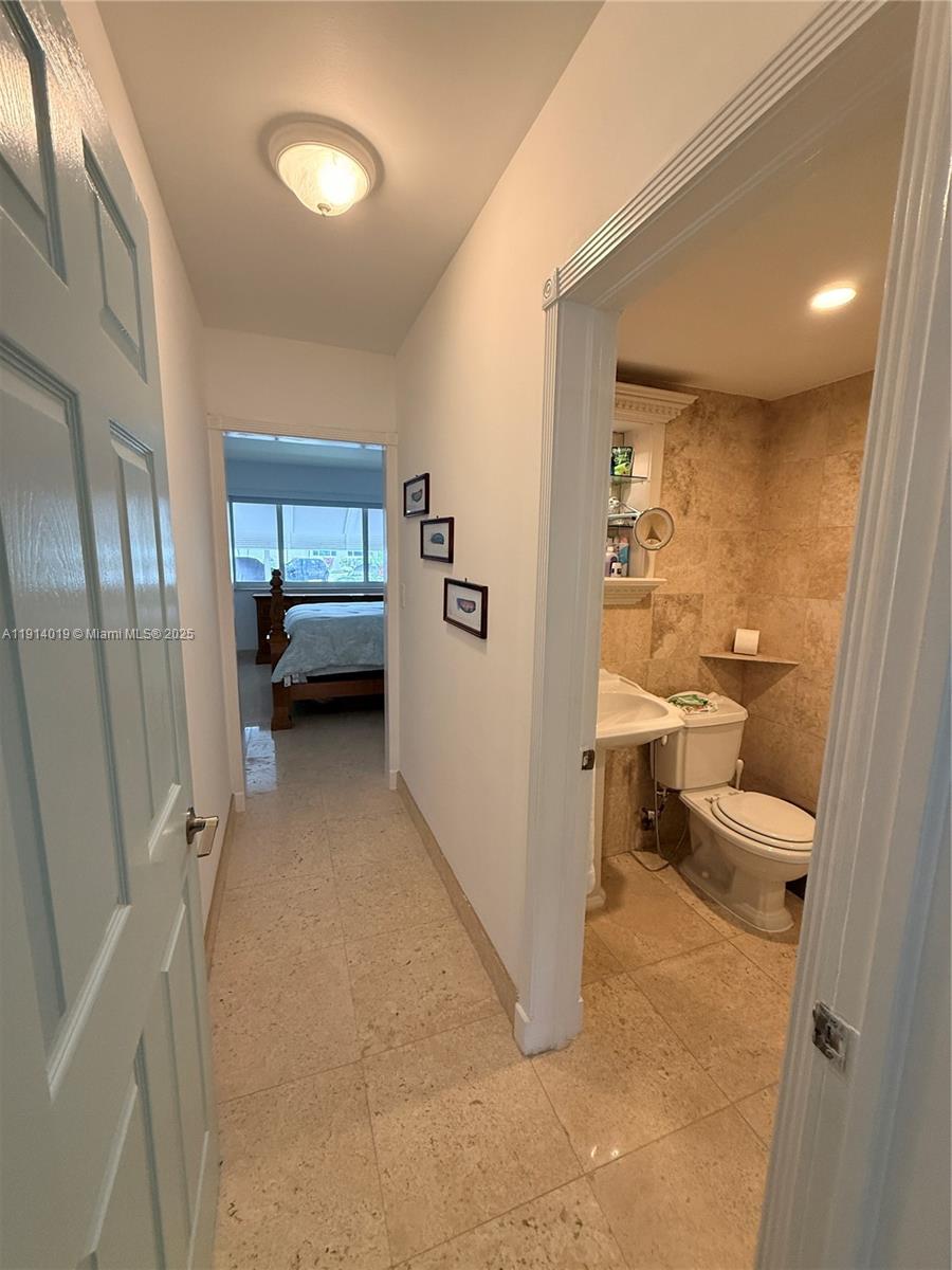 180 Isle Of Venice Drive, Unit 100 Fort Lauderdale, FL 33301 - Photo 12 of 16 a view of a bathroom with a sink and a toilet