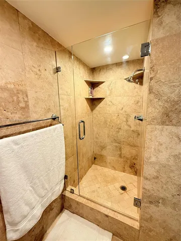 a bathroom with a bathtub and shower