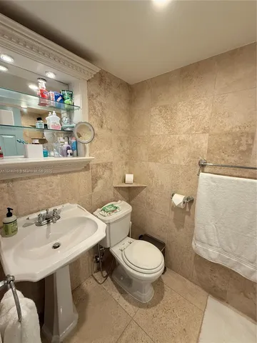 a bathroom with a sink mirror and toilet