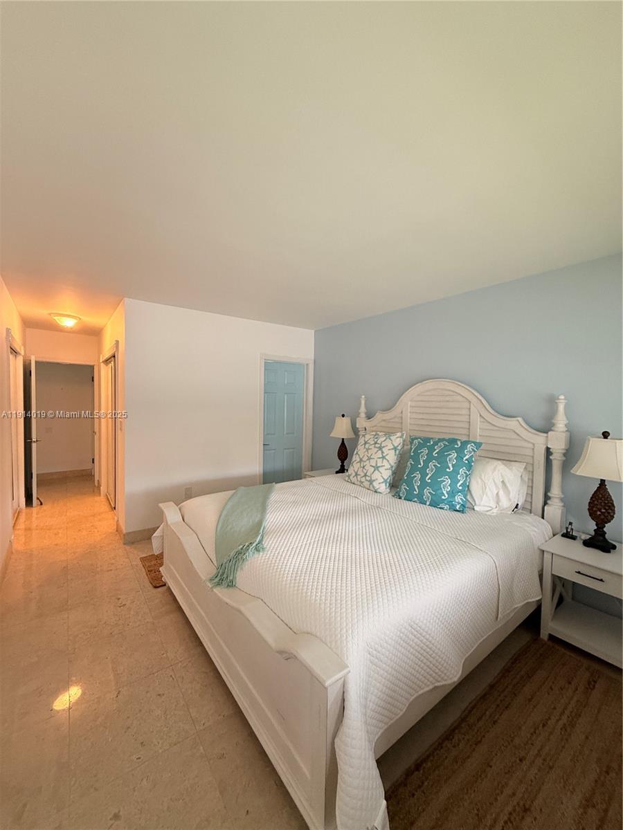 180 Isle Of Venice Drive, Unit 100 Fort Lauderdale, FL 33301 - Photo 8 of 16 a bedroom with a bed and a couch