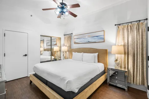 a bedroom with a bed and large window