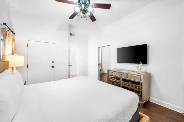 a bedroom with a flat screen tv and a bed