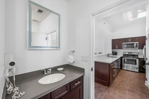 a bathroom with a sink double vanity granite and a mirror