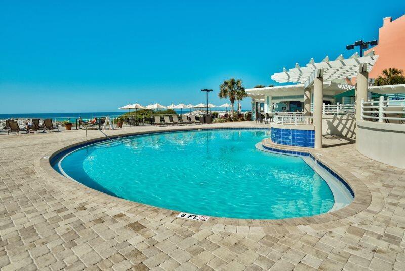 550 Tops'l Beach Boulevard, Unit 1509 Miramar Beach, FL 32550 - Photo 27 of 31 a view of a swimming pool with an outdoor space and seating area