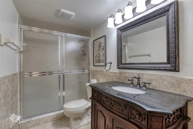 a bathroom with a sink a light fixture and a mirror