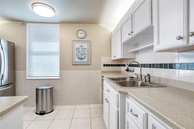 a kitchen with white cabinets and white appliances