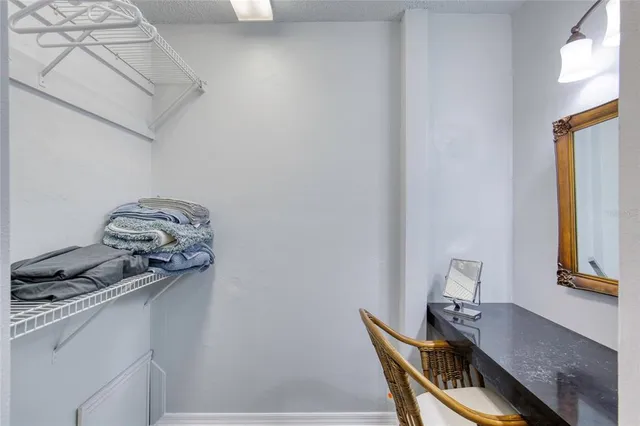 a bathroom with a granite countertop sink mirror vanity and toilet