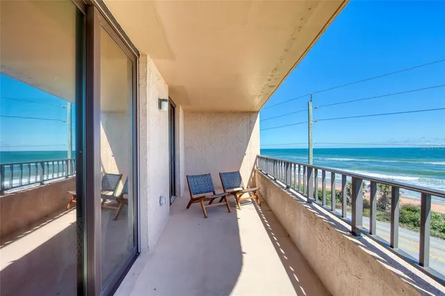 a view of a house with a yard and potted plants
