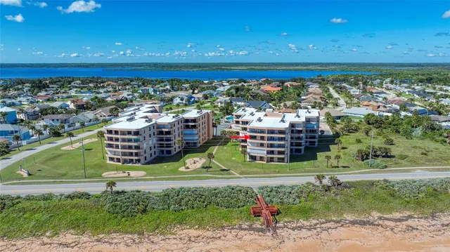 an aerial view of a house with a swimming pool yard and outdoor seating