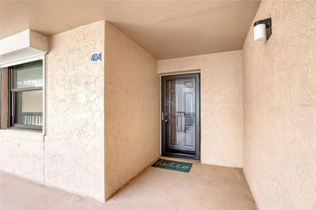 a view of a hallway with closet and front door