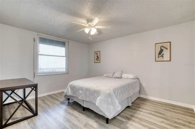a bathroom with a granite countertop toilet sink and mirror