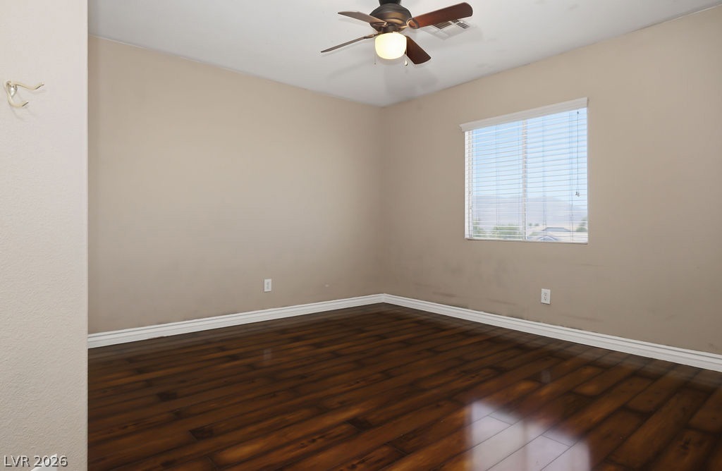9712 North Running Rabbit Street Las Vegas, NV 89143 - Photo 29 of 42 Hardwood floors and a ceiling fan create a comfortable atmosphere in this inviting bedroom.