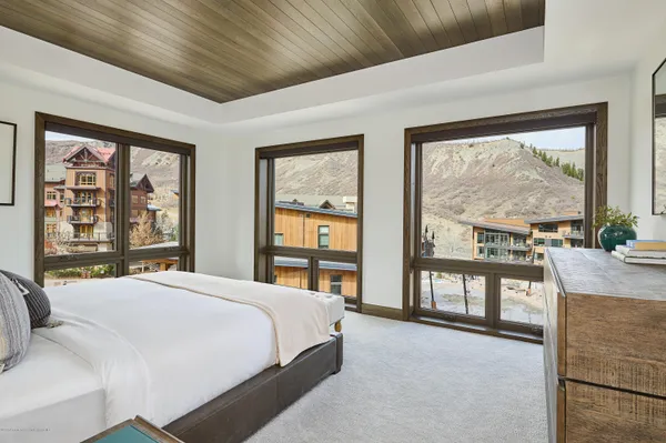 a bedroom with a large bed and a large window