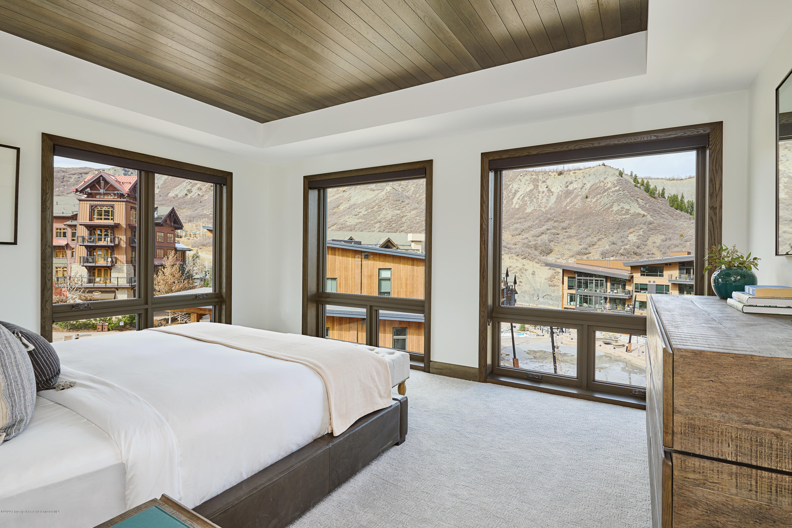 65 Wood Road, Unit 433 Snowmass Village, CO 81615 - Photo 12 of 27 a bedroom with a large bed and a large window