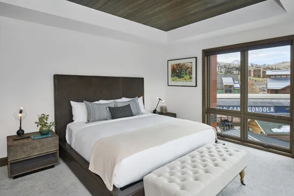 a bedroom with a bed and glass window