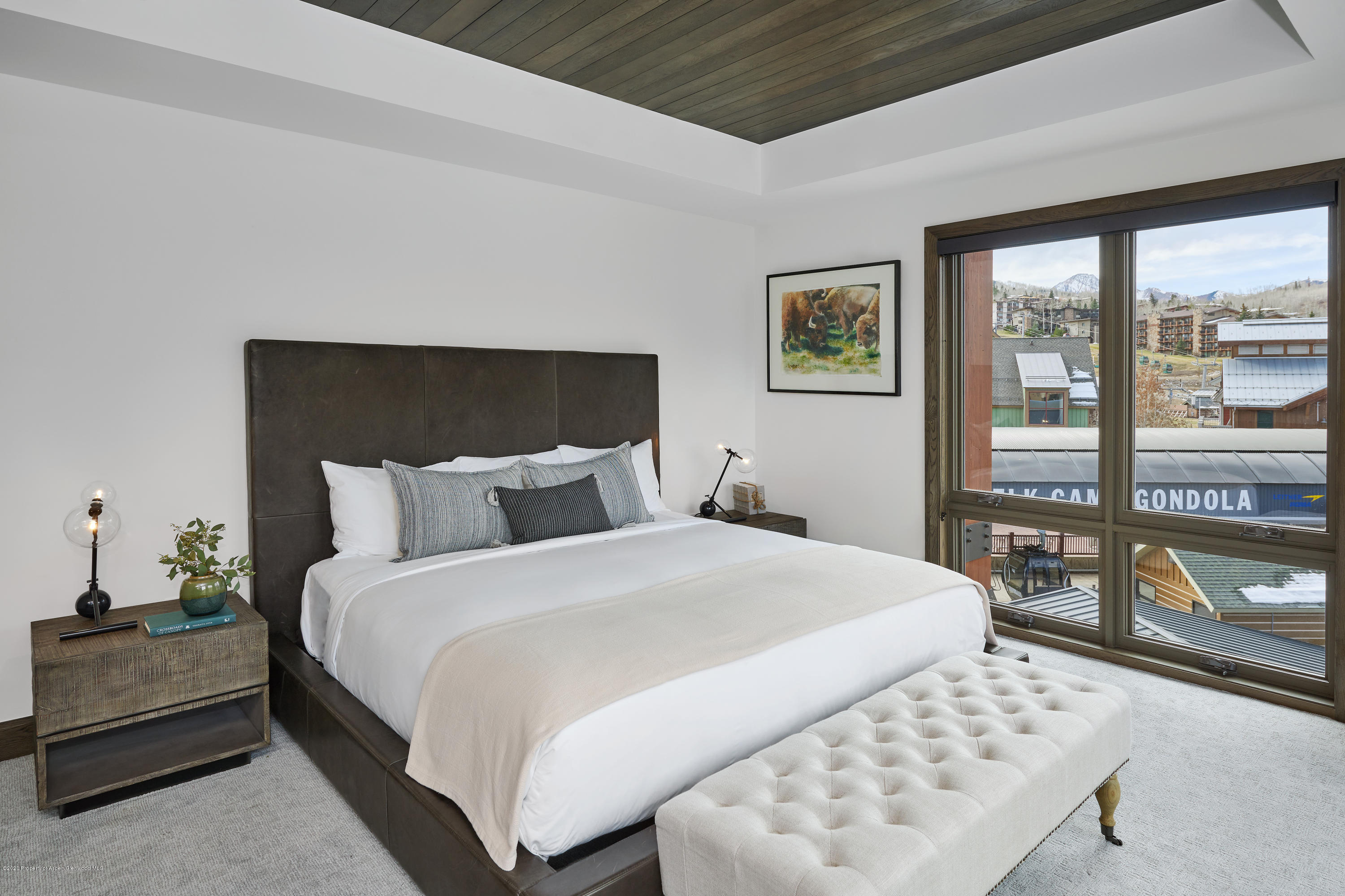 65 Wood Road, Unit 433 Snowmass Village, CO 81615 - Photo 13 of 27 a bedroom with a bed and glass window