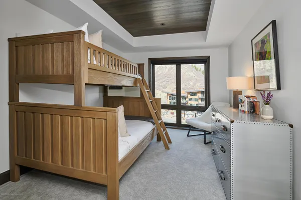 a living room with furniture tv and large windows