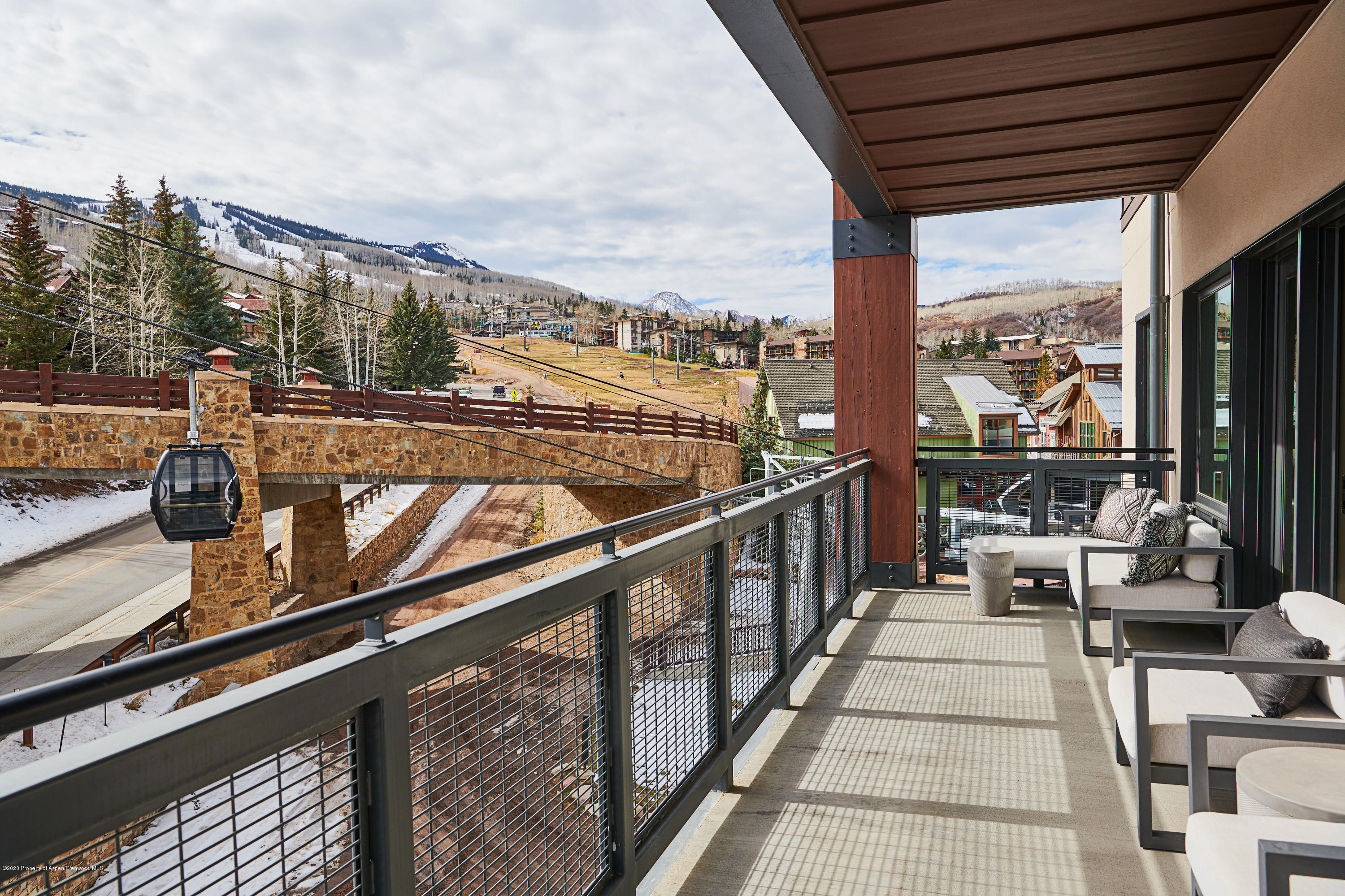 65 Wood Road, Unit 433 Snowmass Village, CO 81615 - Photo 19 of 27 a view of a balcony with wooden floor next to a patio