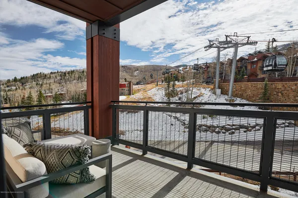 a view of a balcony with furniture