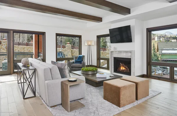a living room with furniture a flat screen tv and a fireplace