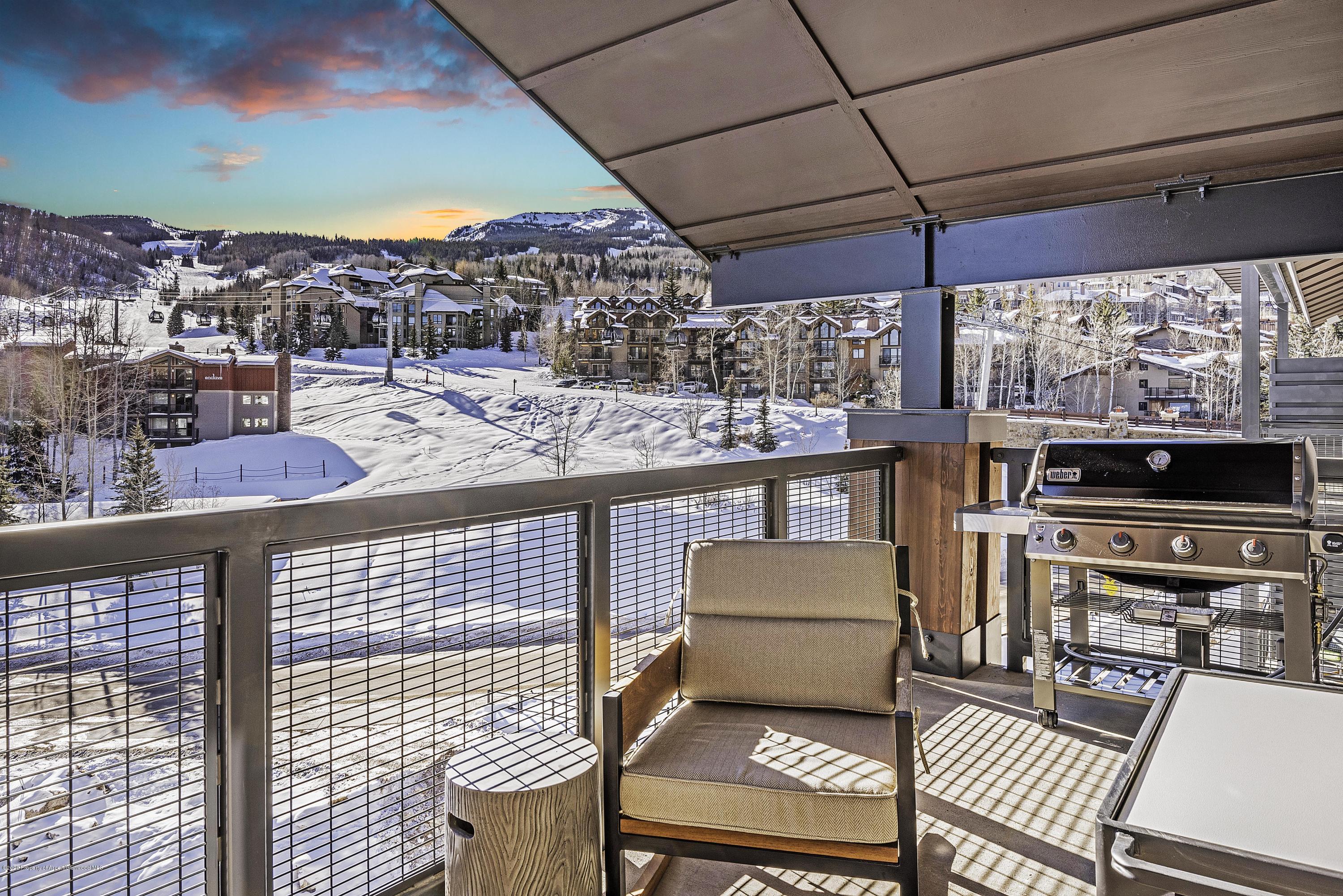 65 Wood Road, Unit 433 Snowmass Village, CO 81615 - Photo 21 of 27 a view of a chairs and table in the terrace