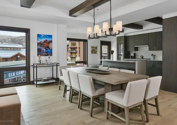 a view of a dining room with furniture and a chandelier