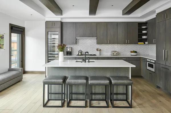 a kitchen with a table chairs sink and stove